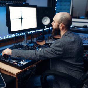 Sound engineer at the monitor, recording studio